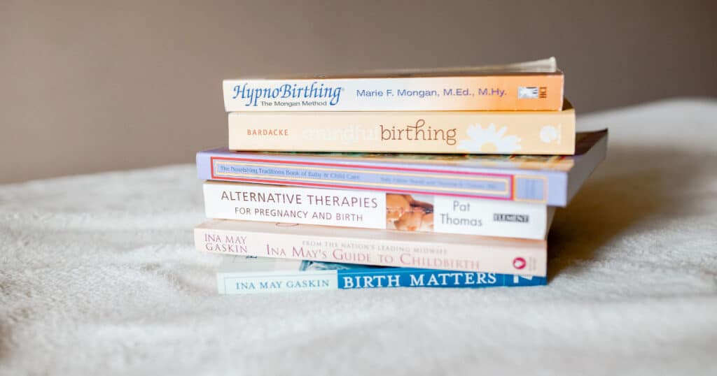 a stack of books on hypnobirthing methods