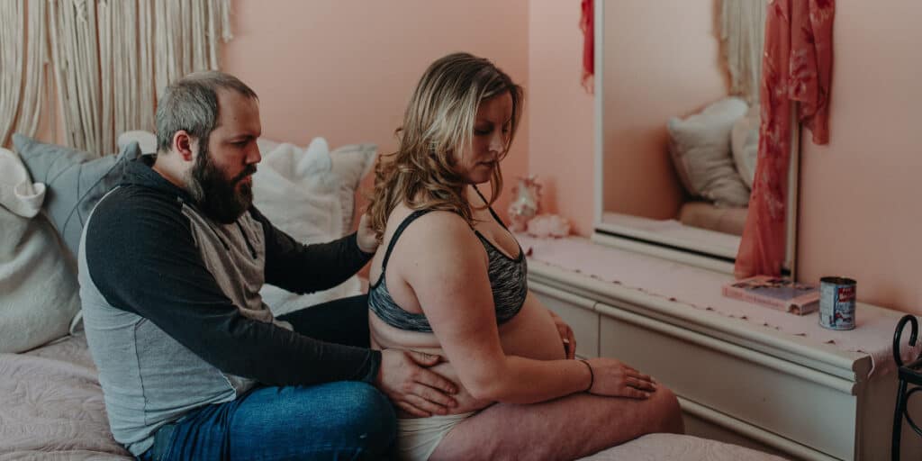 a partner supports his spouse during pregnancy and labor
